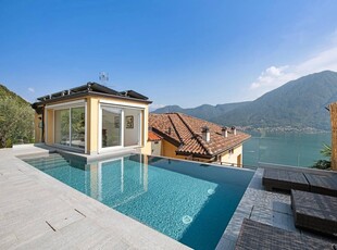 Casa vacanze Colonno Attico con vista lago, piscina infinita, idromassaggio e giardino